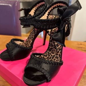 Dressy black high heeled sandals.